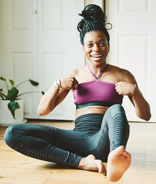 Woman in yoga attire smiling